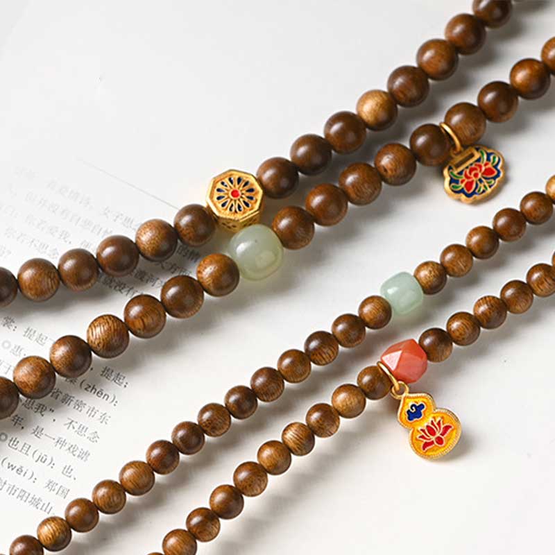 Bracelet Mala tibétain de protection et de calme en bois de rose avec Buddha Stones