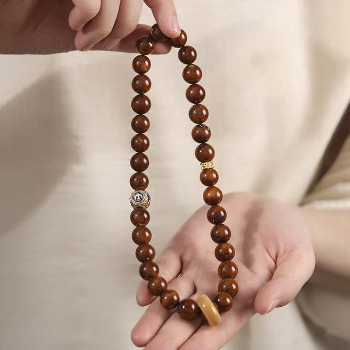 Bracelet double tour en Buddha Stones tibétaines naturelles violettes et dorées avec graines de Bodhi et de richesse