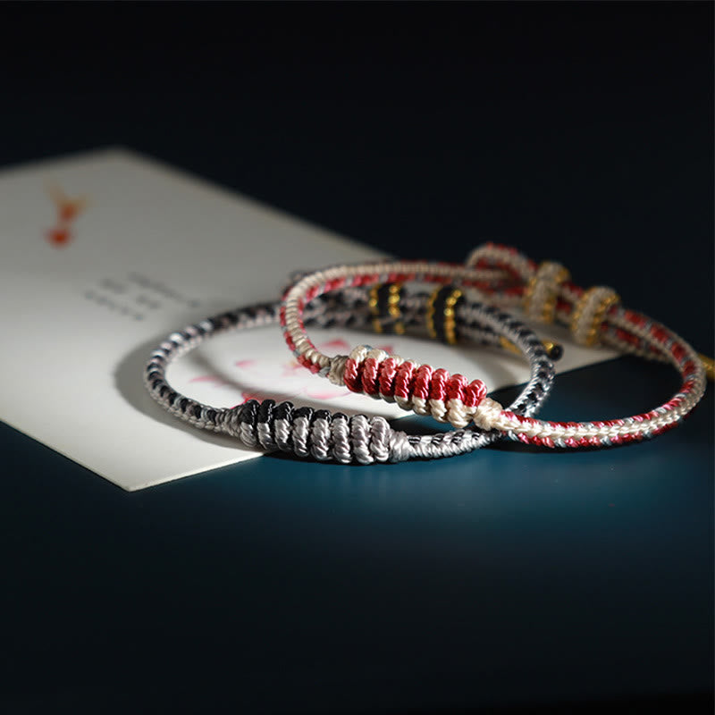 Bracelet de protection tressé à huit fils en Buddha Stones tibétain fait à la main avec roue de prière et nœud de paix