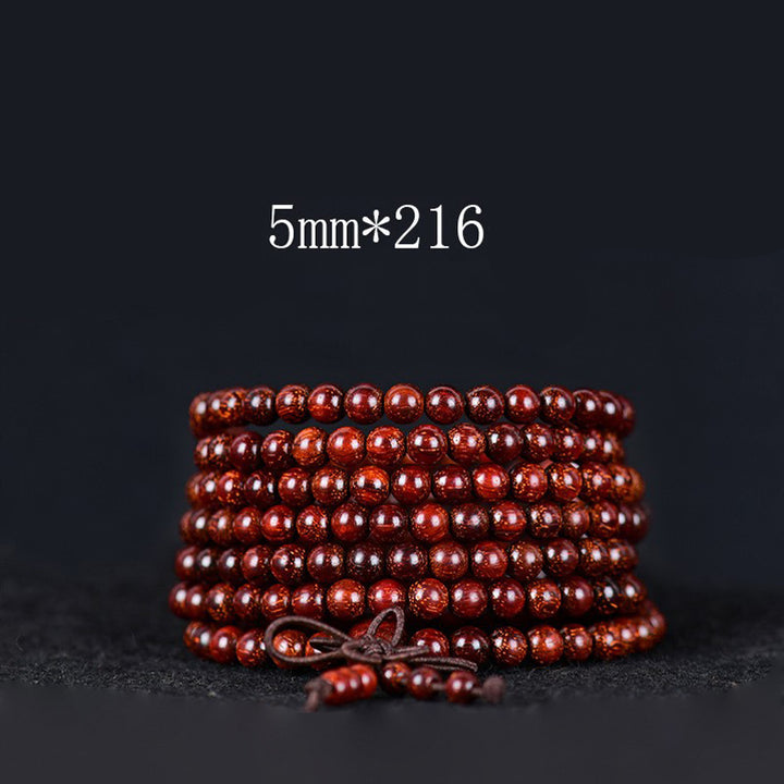 Bracelet d'équilibre tibétain en petites feuilles de santal rouge avec Buddha Stones