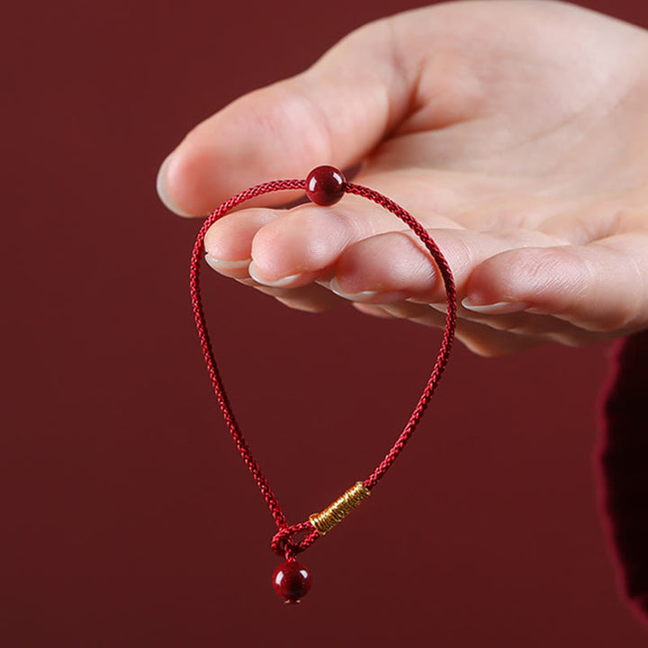 Bracelet en fil rouge avec bénédiction en agate rouge cinabre naturelle de Buddha Stones