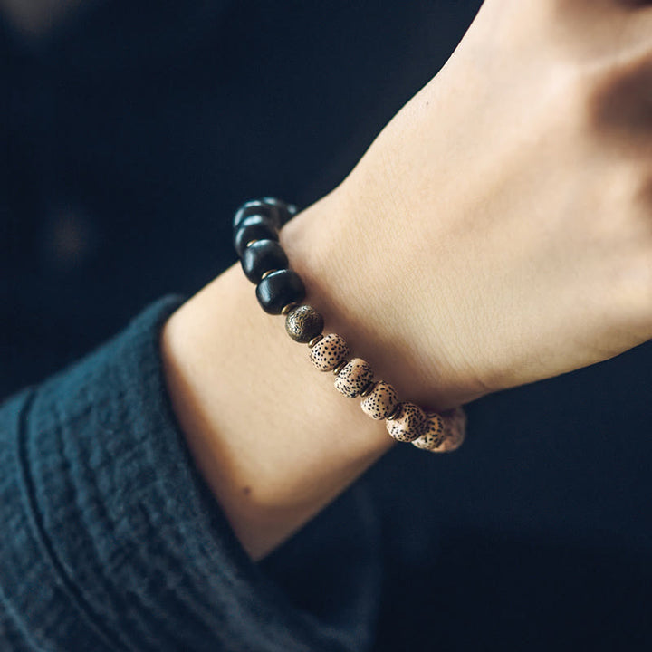Bracelet de paix en cuivre et bois d'ébène avec Buddha Stones et graines de Bodhi tibétaines
