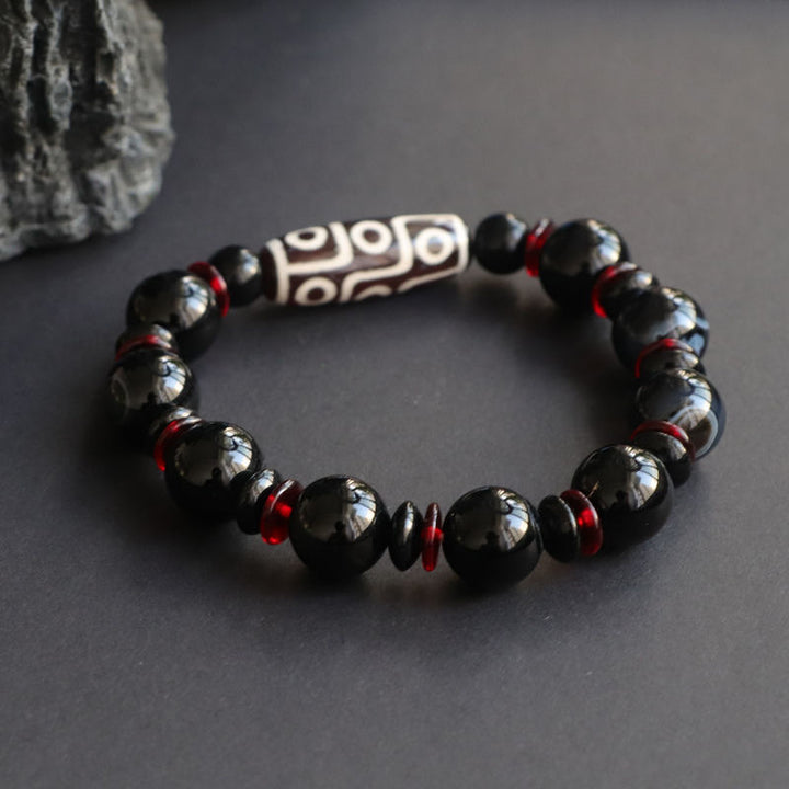 Bracelet de protection de richesse en perles dzi à neuf yeux en onyx noir de Buddha Stones
