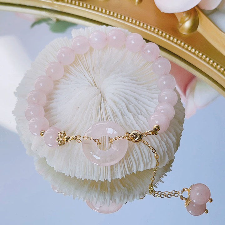 Bracelet à breloques en cristal rose naturel avec boucle de paix et Buddha Stones - Cristal rose (Apaisant♥Chaleur) - image 0