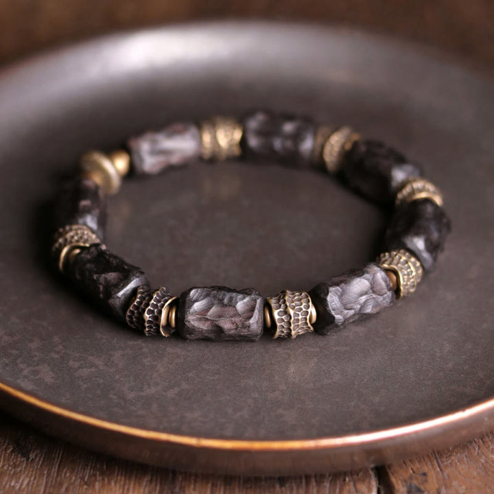 Bracelet tibétain en bois d'ébène et cuivre avec Buddha Stones pour la paix et le calme