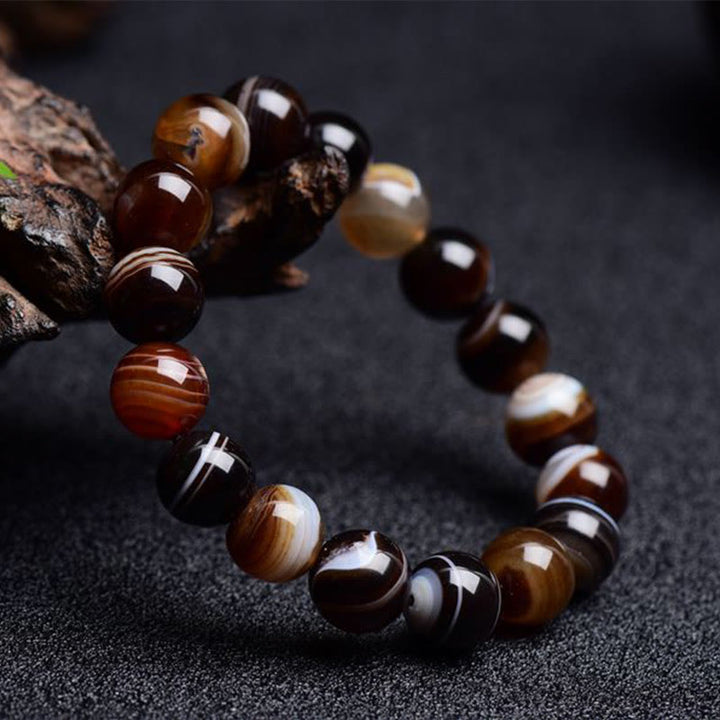 Bracelet de bonheur positif tibétain en sardonyx Buddha Stones