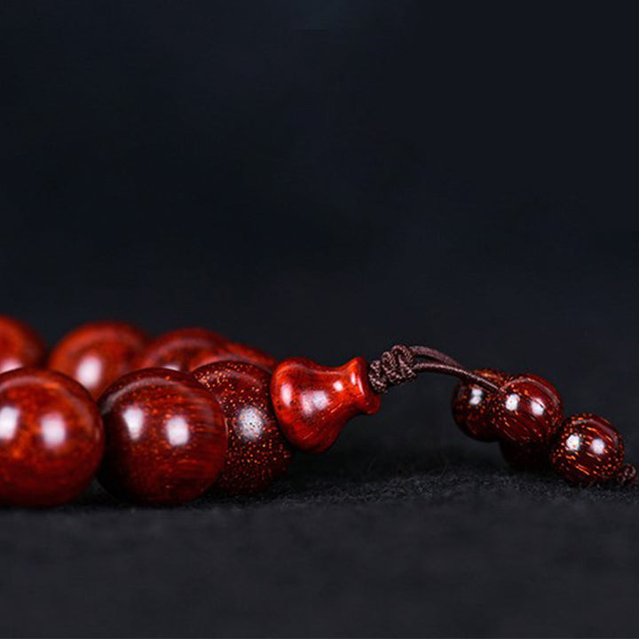 Bracelet d'équilibre tibétain en petites feuilles de santal rouge avec Buddha Stones