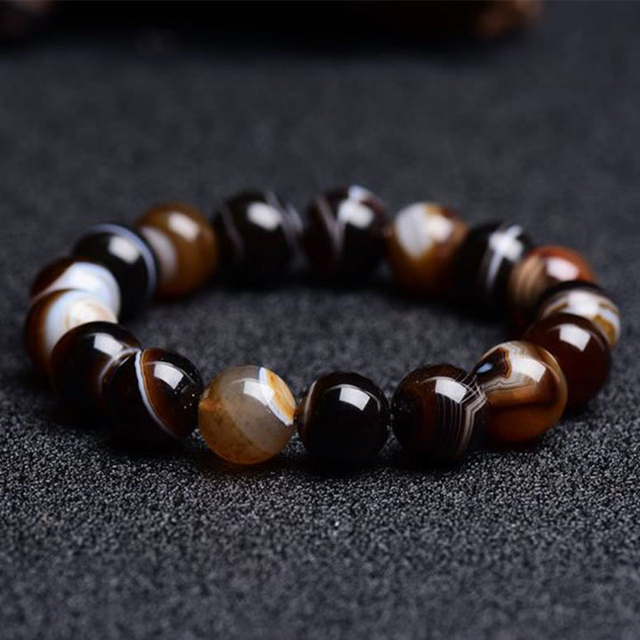 Bracelet de bonheur positif tibétain en sardonyx Buddha Stones