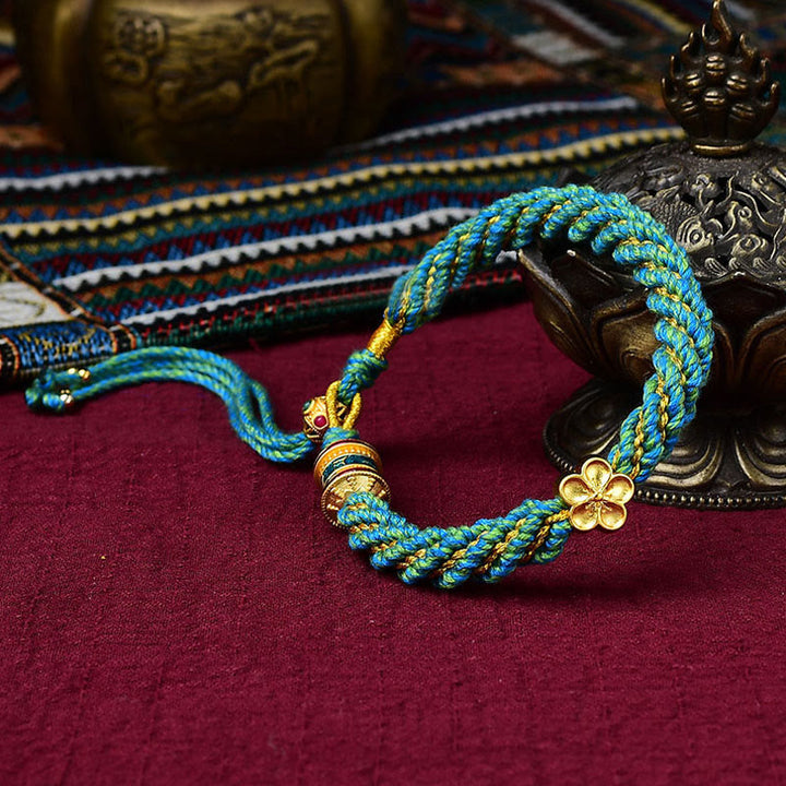 Bracelet en corde tissée avec breloque en forme de fleur et roue de prière en Buddha Stones faites à la main avec cinq dieux de la richesse et de la chance