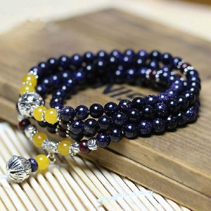 Bracelet Mala en grès bleu avec breloques de richesse et Buddha Stones