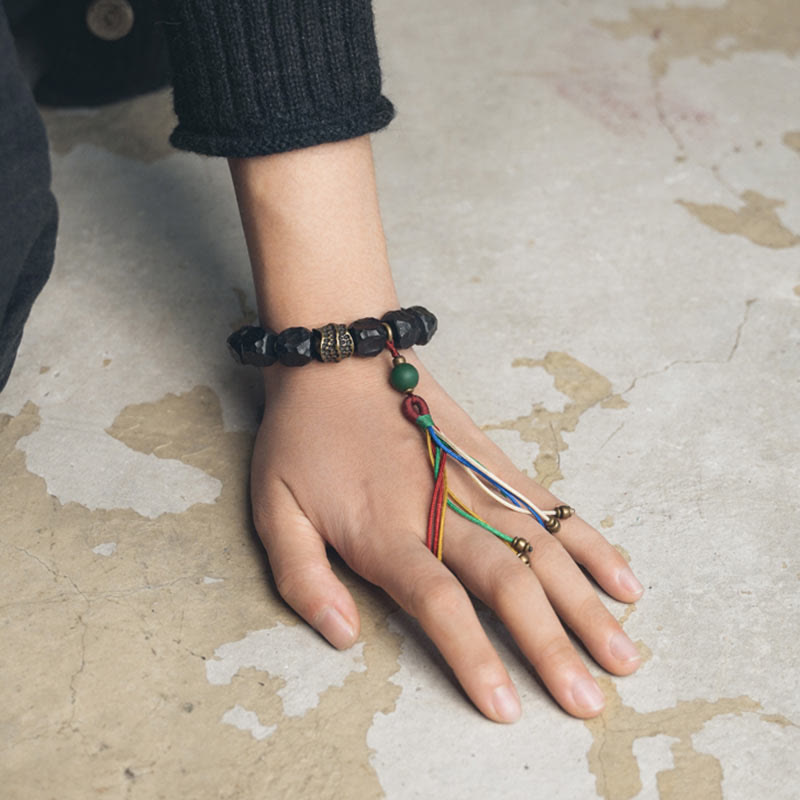 Bracelet Mala en bois d'ébène et cuivre avec Buddha Stones et pompon de paix