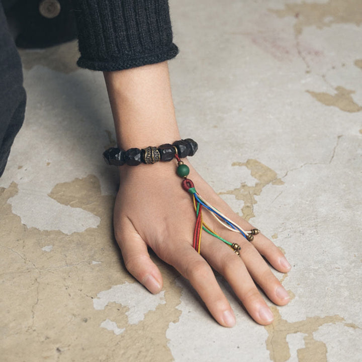 Bracelet Mala en bois d'ébène et cuivre avec Buddha Stones et pompon de paix