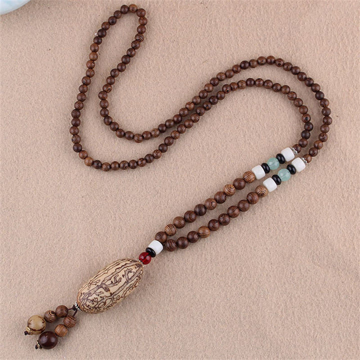 Collier pendentif protection éléphant en Buddha Stones tibétain en bois de wengé Bodhi Seed Agate