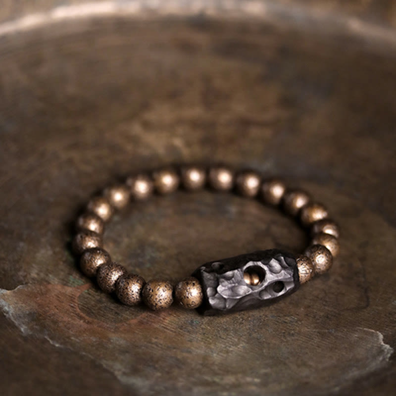 Bracelet de perles en bois d'ébène et cuivre avec Buddha Stones et équilibre