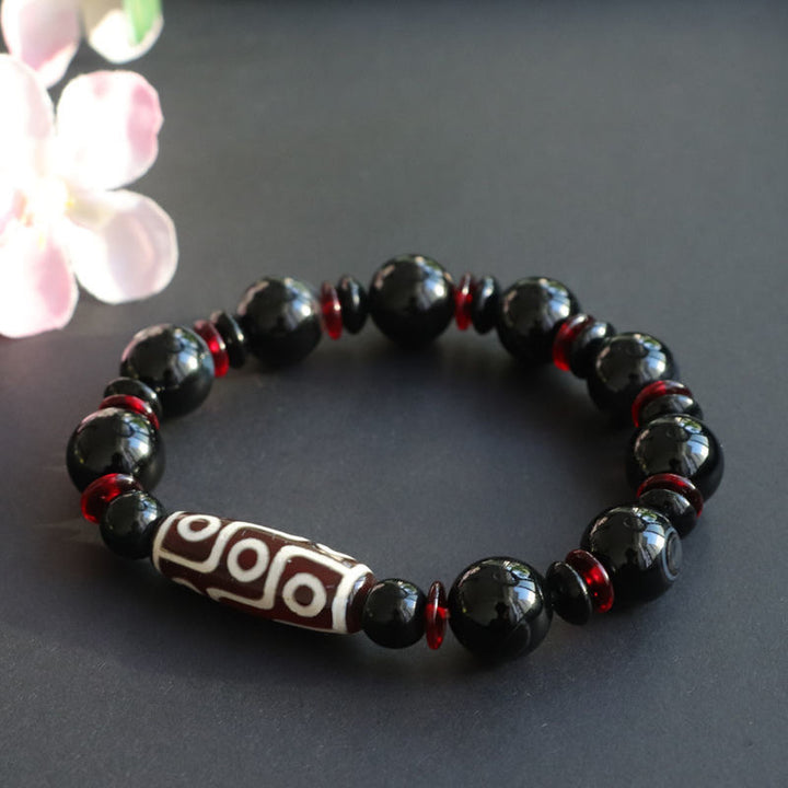 Bracelet de protection de richesse en perles dzi à neuf yeux en onyx noir de Buddha Stones