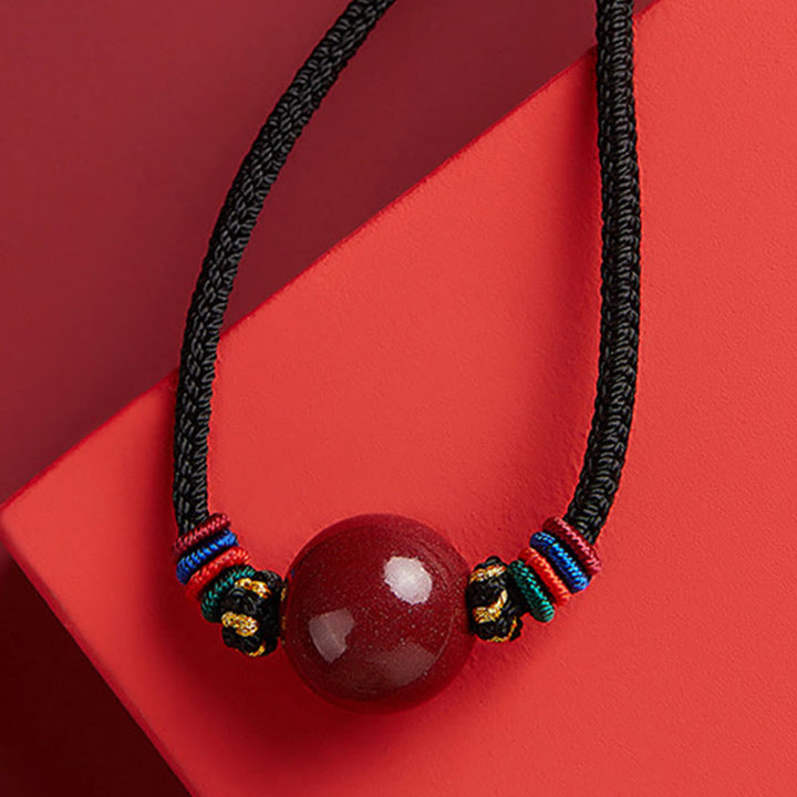 Collier avec pendentif en perles de cinabre et Buddha Stones