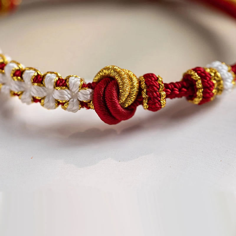 Bracelet porte-bonheur en corde avec breloque en fleur de pêcher et nœud d'amour véritable fait à la main par Buddha Stones