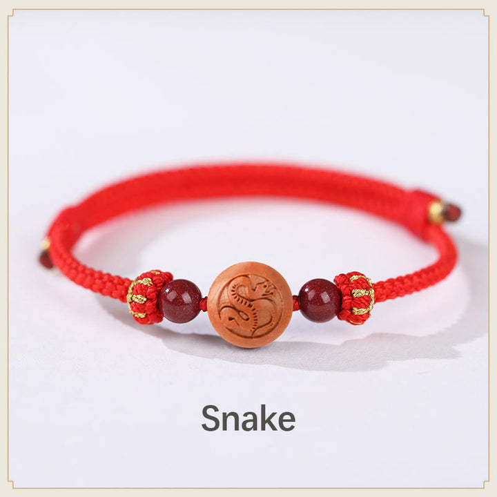 Bracelet de richesse en bois de pêche naturel Buddha Stones et caractère Fu du zodiaque chinois sculpté en cinabre