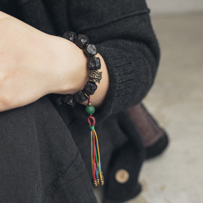 Bracelet Mala en bois d'ébène et cuivre avec Buddha Stones et pompon de paix