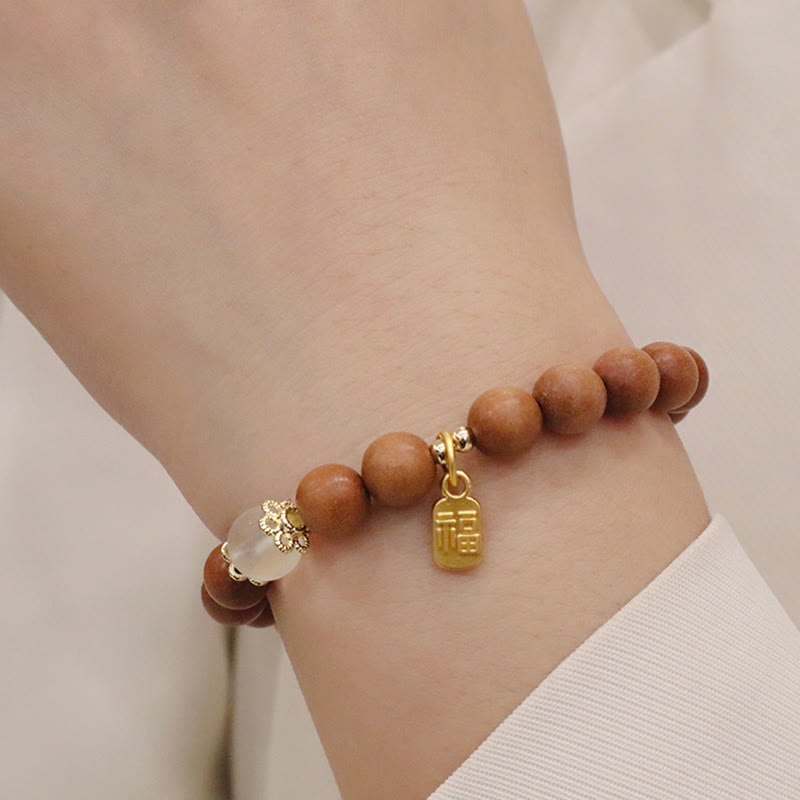 Bracelet de protection à breloques en bois de santal et œil de chat Fu avec Buddha Stones