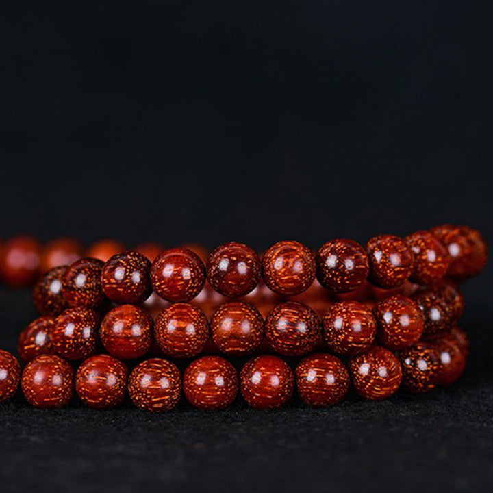 Bracelet d'équilibre tibétain en petites feuilles de santal rouge avec Buddha Stones