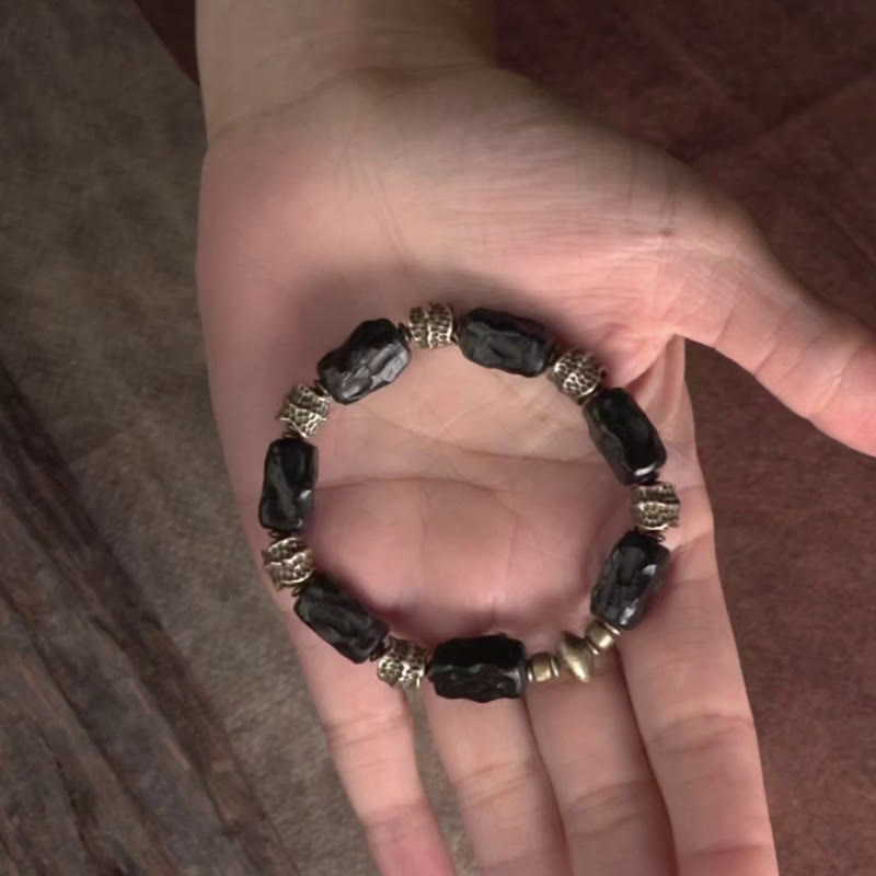 Bracelet tibétain en bois d'ébène et cuivre avec Buddha Stones pour la paix et le calme