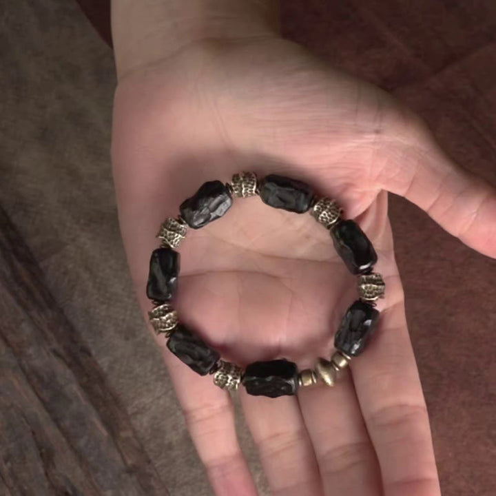 Bracelet tibétain en bois d'ébène et cuivre avec Buddha Stones pour la paix et le calme