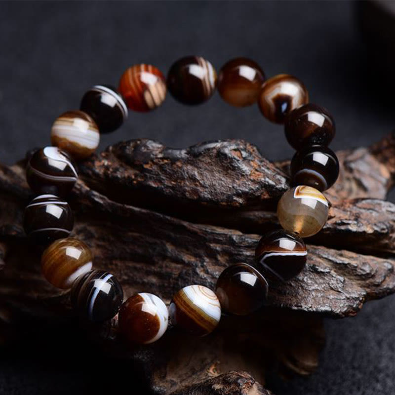 Bracelet de bonheur positif tibétain en sardonyx Buddha Stones