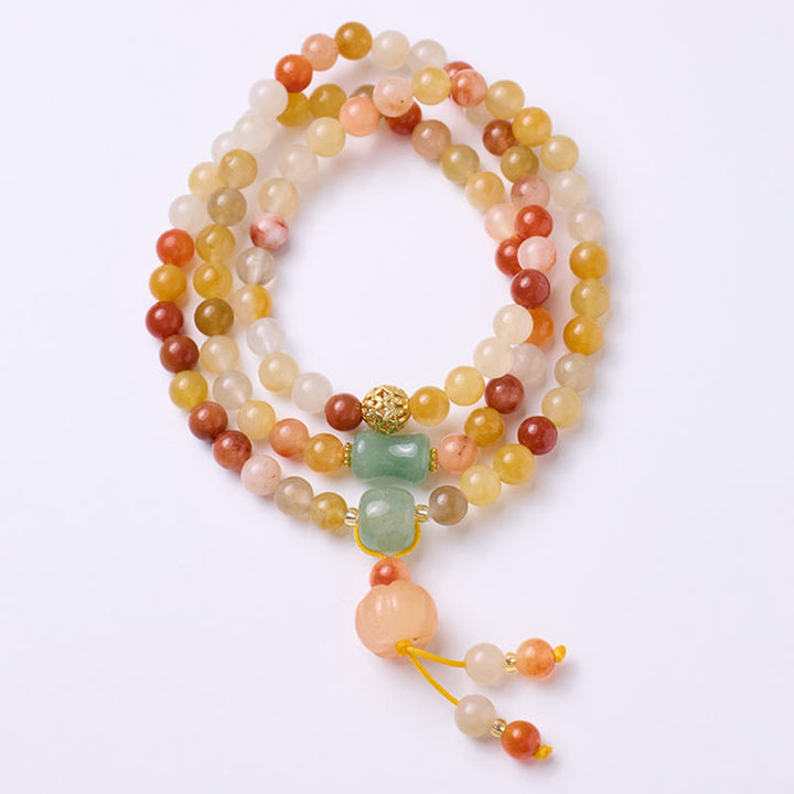 Bracelet triple tour en jade doré et soie naturelle avec breloque citrouille et Buddha Stones