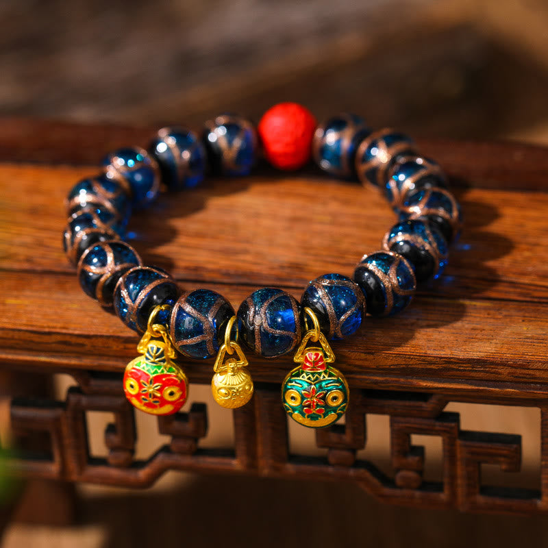 Bracelet de perles de cinabre colorées représentant une famille de bêtes avaleuses d'or