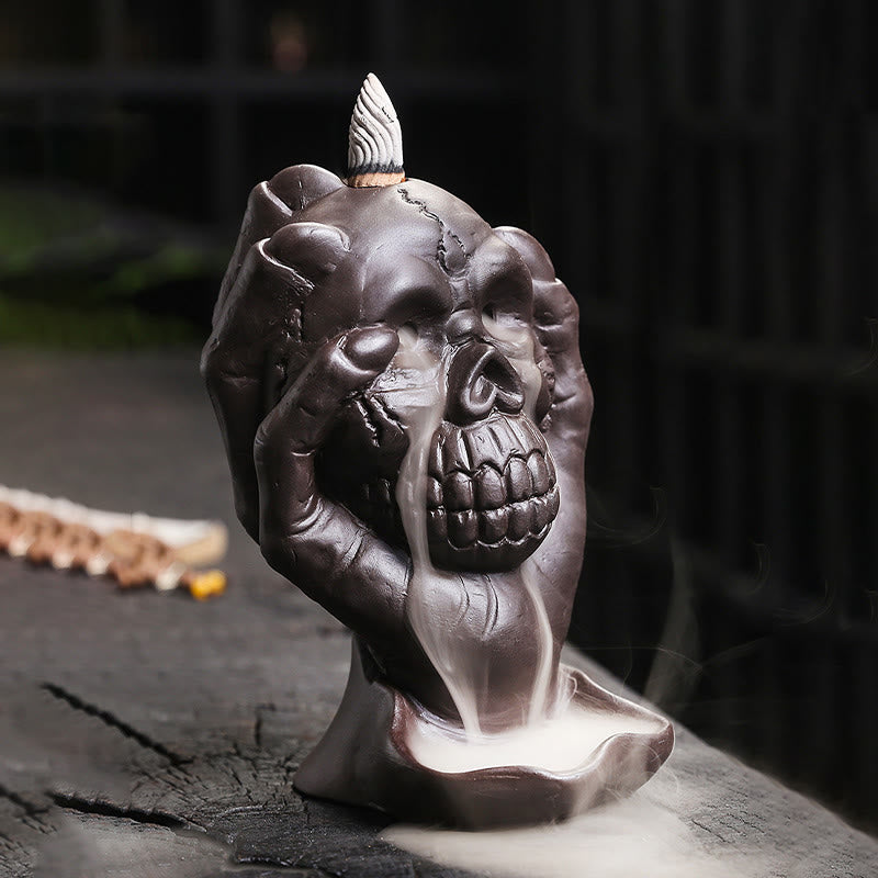 Brûleur d'encens spirituel en argile violette avec tête de mort et main fantôme en Buddha Stones