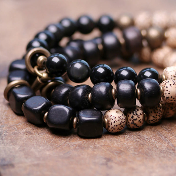 Bracelet de paix en cuivre et bois d'ébène avec Buddha Stones et graines de Bodhi tibétaines