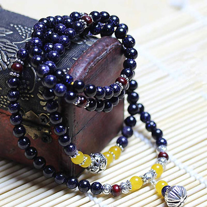 Bracelet Mala en grès bleu avec breloques de richesse et Buddha Stones