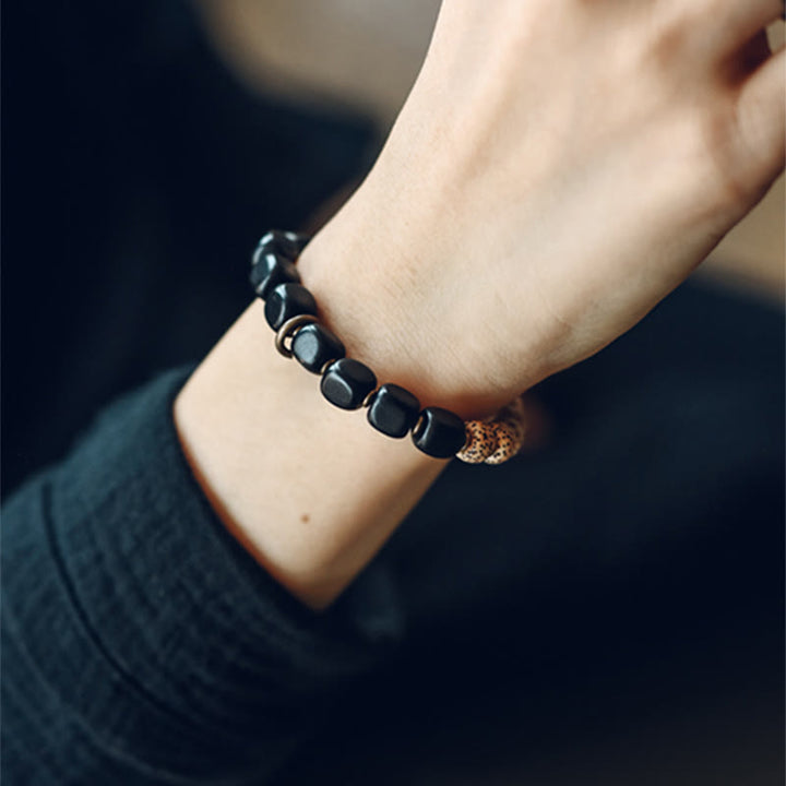 Bracelet de paix en cuivre et bois d'ébène avec Buddha Stones et graines de Bodhi tibétaines