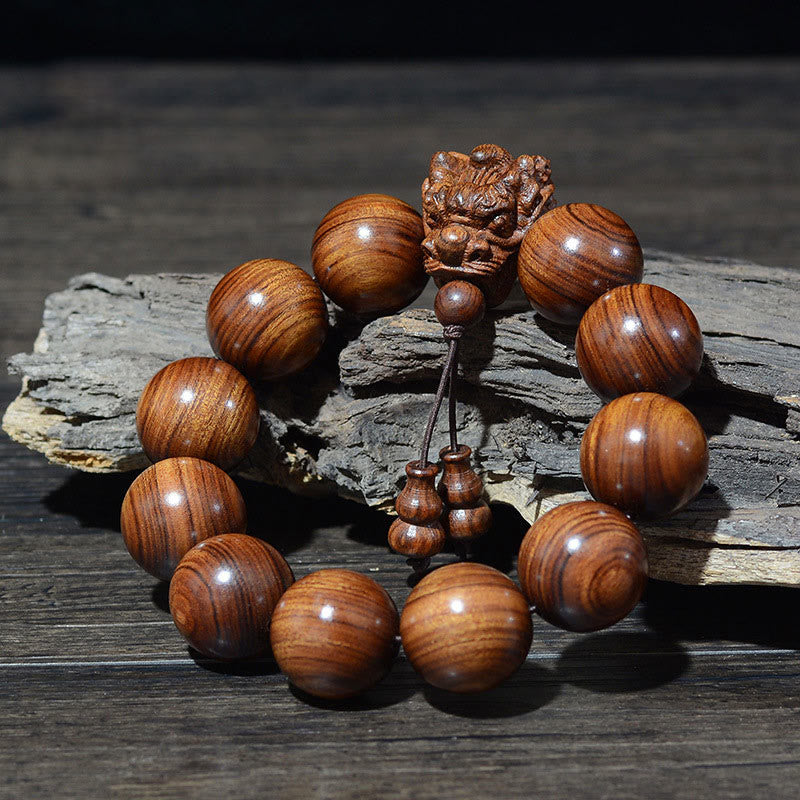 Bracelet de protection sculpté en forme de dragon en bois de santal vert et bois de rose avec petites feuilles de Buddha Stones