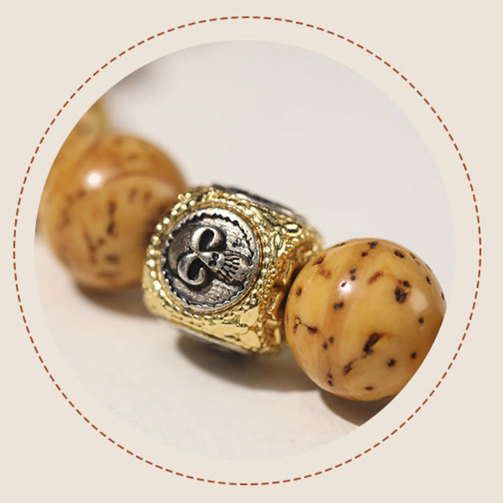 Bracelet double tour en Buddha Stones tibétaines naturelles violettes et dorées avec graines de Bodhi et de richesse