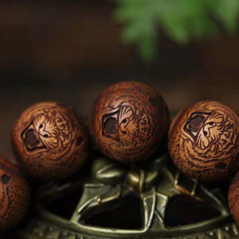 Bracelet de protection du tigre gravé en bois de rose tibétain Buddha Stones