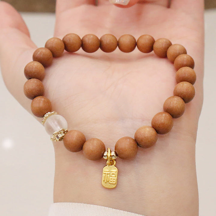 Bracelet de protection à breloques en bois de santal et œil de chat Fu avec Buddha Stones
