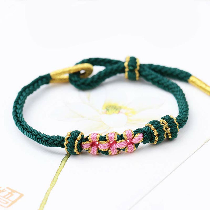 Bracelet tressé fait main à huit brins avec trois fleurs de pêcher et Buddha Stones