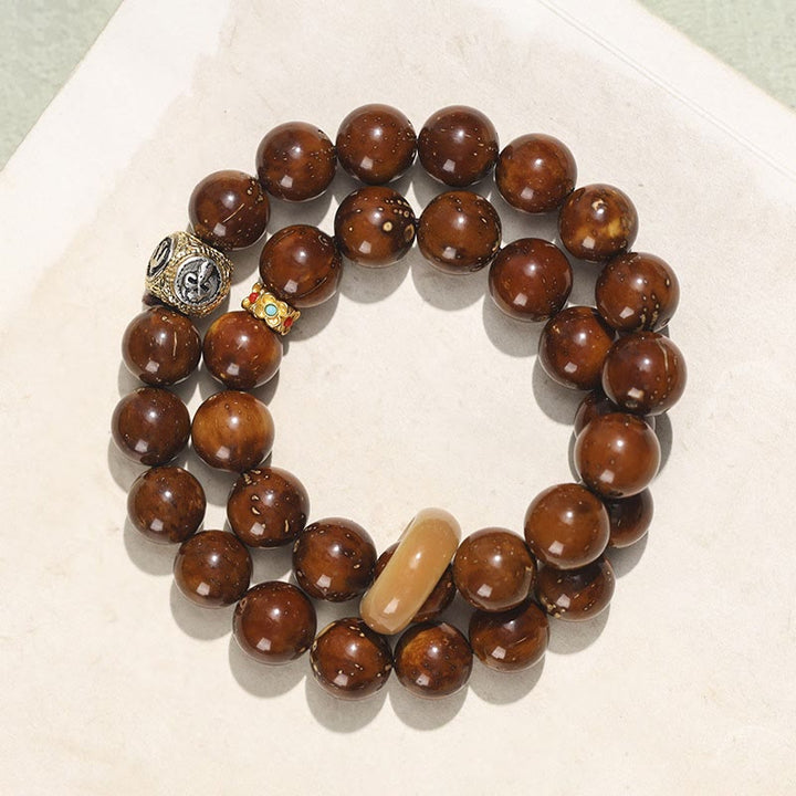 Bracelet double tour en Buddha Stones tibétaines naturelles violettes et dorées avec graines de Bodhi et de richesse