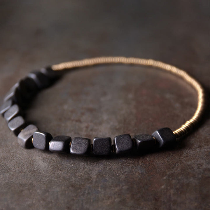 Bracelet double tour en cuivre et bois d'ébène tibétain avec Buddha Stones