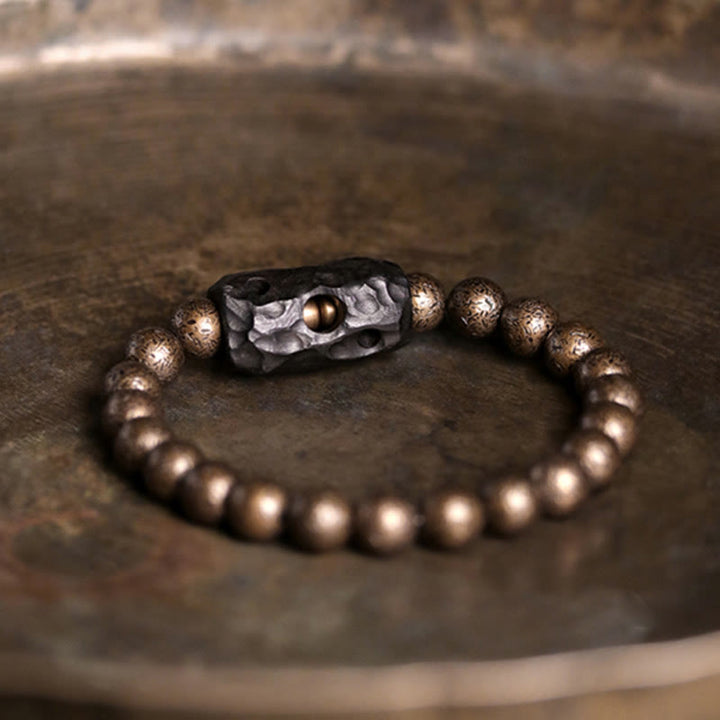 Bracelet de perles en bois d'ébène et cuivre avec Buddha Stones et équilibre