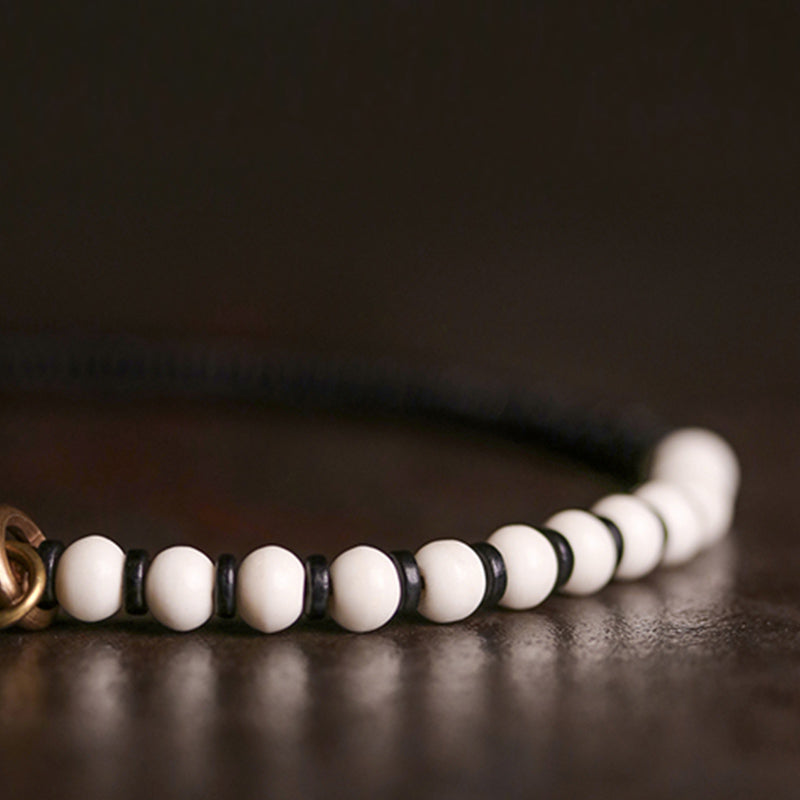 Bracelet couple force en bois d'ébène et cuivre, perles d'os et Buddha Stones