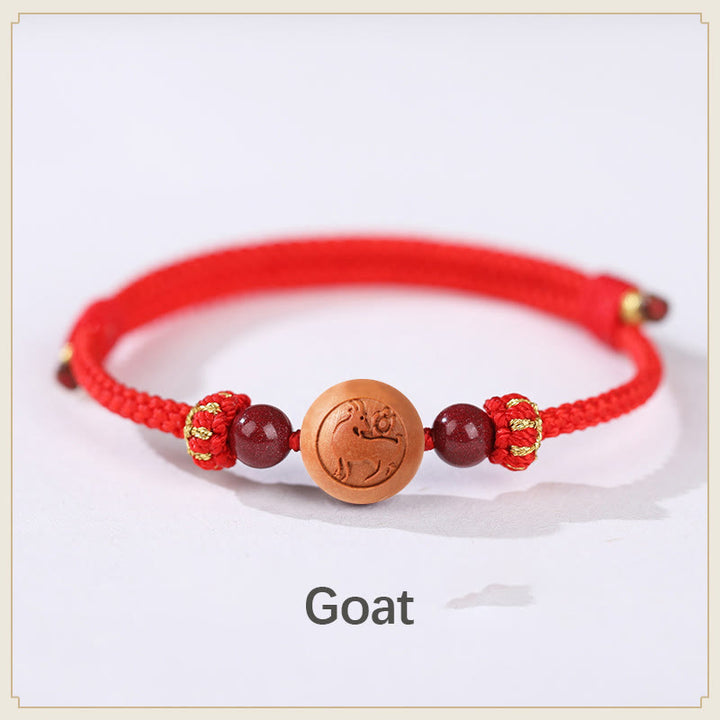 Bracelet de richesse en bois de pêche naturel Buddha Stones et caractère Fu du zodiaque chinois sculpté en cinabre