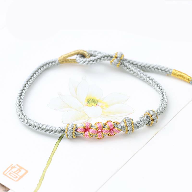 Bracelet tressé fait main à huit brins avec trois fleurs de pêcher et Buddha Stones