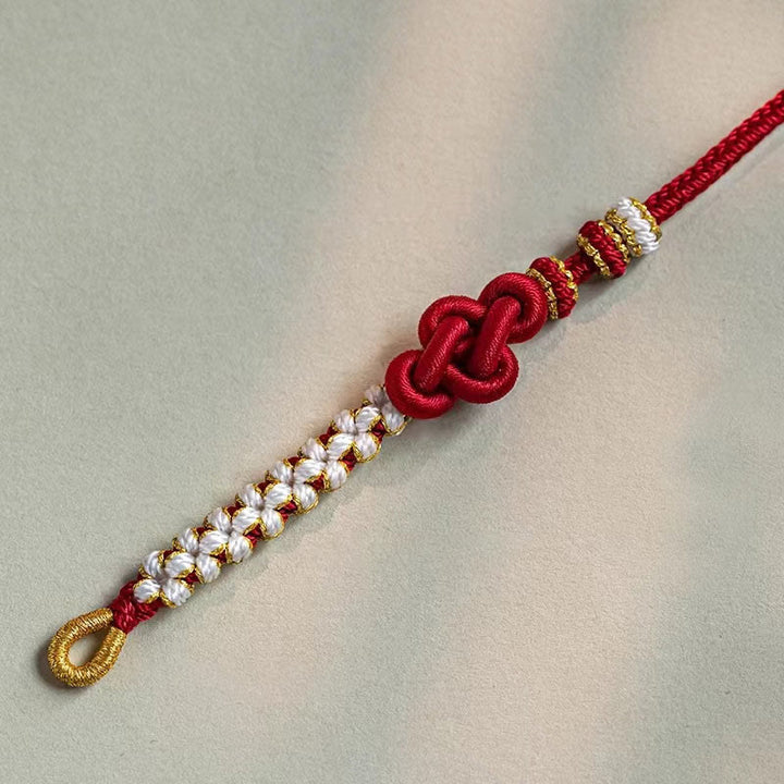 Bracelet porte-bonheur en corde avec breloque en fleur de pêcher et nœud d'amour véritable fait à la main par Buddha Stones