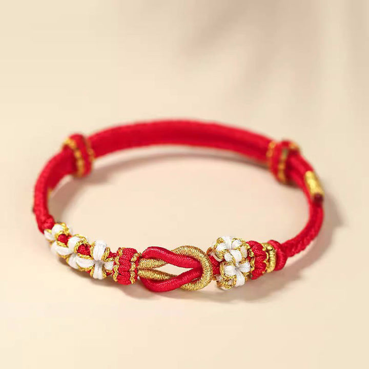 Bracelet de protection porte-bonheur fait main en Buddha Stones avec nœud en fleur de pêcher à huit fils