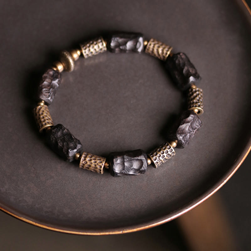 Bracelet tibétain en bois d'ébène et cuivre avec Buddha Stones pour la paix et le calme