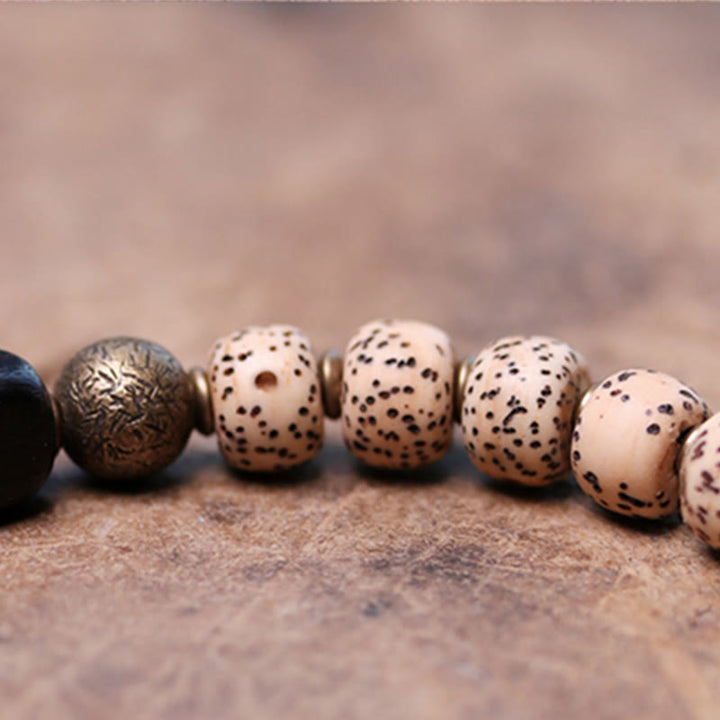 Bracelet de paix en cuivre et bois d'ébène avec Buddha Stones et graines de Bodhi tibétaines