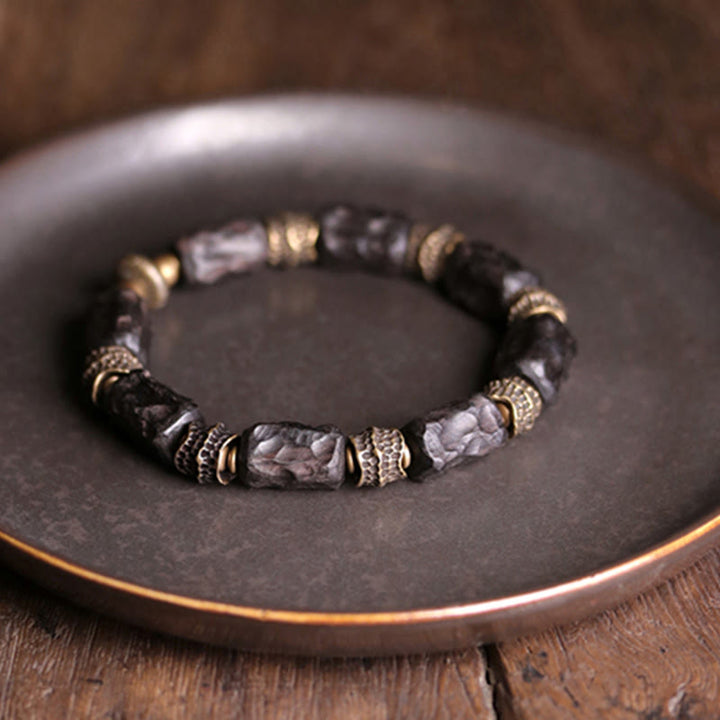 Bracelet tibétain en bois d'ébène et cuivre avec Buddha Stones pour la paix et le calme